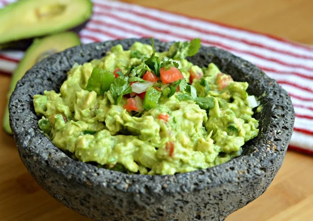 Authentic Mexican guacamole prepared in a traditional molcajete
