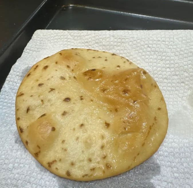 Fried tortillas draining on paper towels, showing their crispy texture and golden color for Taco Bell Mexican Pizza.
