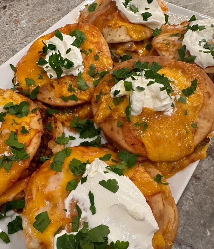 Finished Taco Bell Mexican Pizza topped with sour cream and parsley, ready to eat.