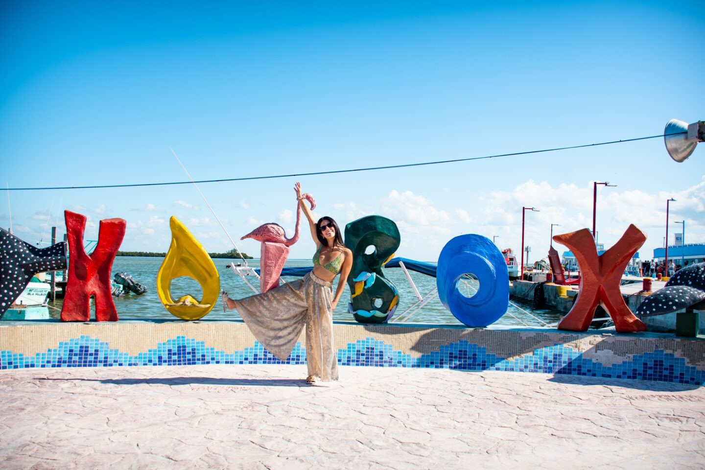 Secluded beach on Holbox Island with clear turquoise water and palm trees