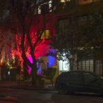 Red Tree House at night in Mexico City, showcasing its charming red fairy lights