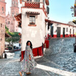 Cobblestone streets and white colonial buildings in Taxco Mexico