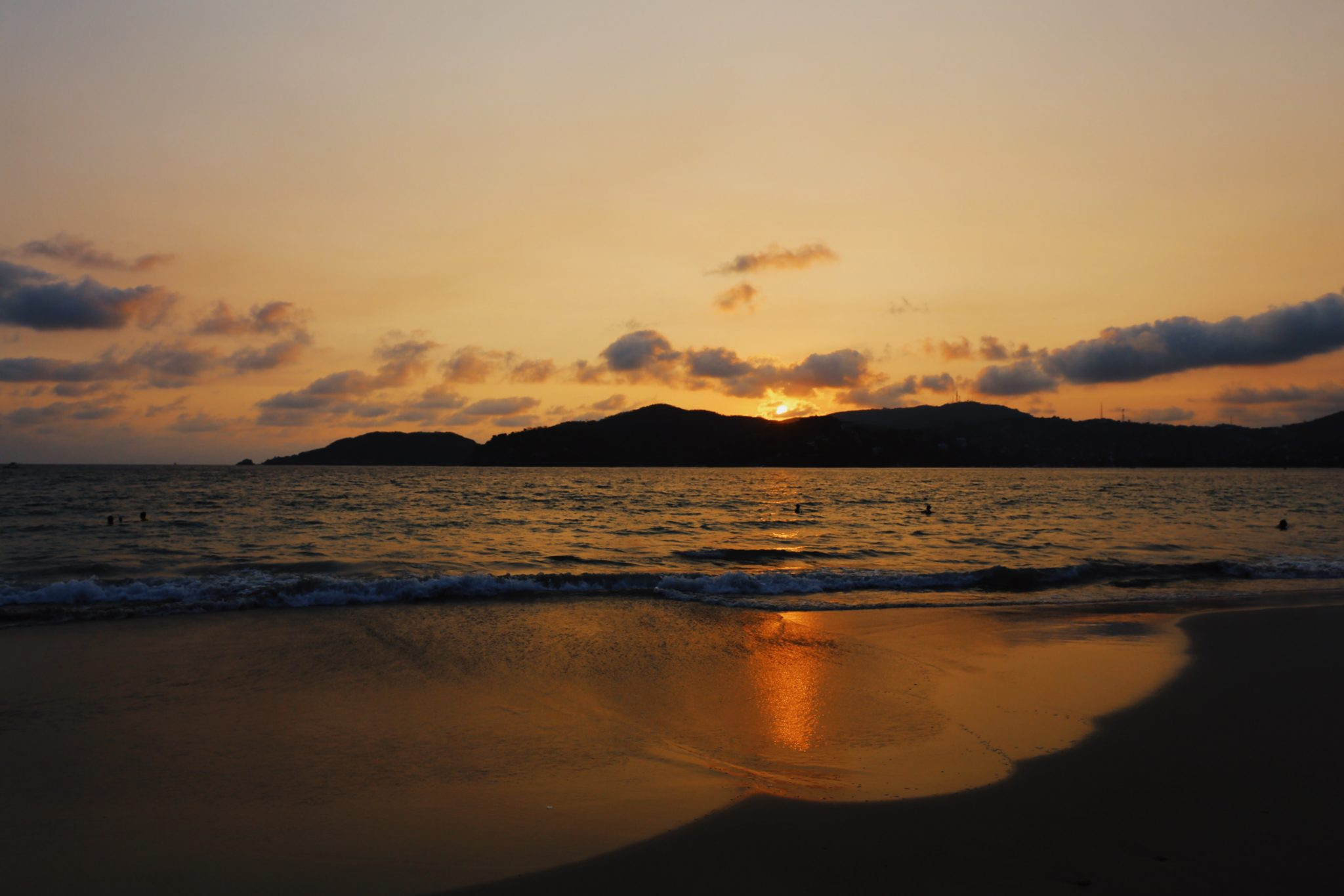 Sunset over the beach in Zihuatanejo, Mexico casting warm colors