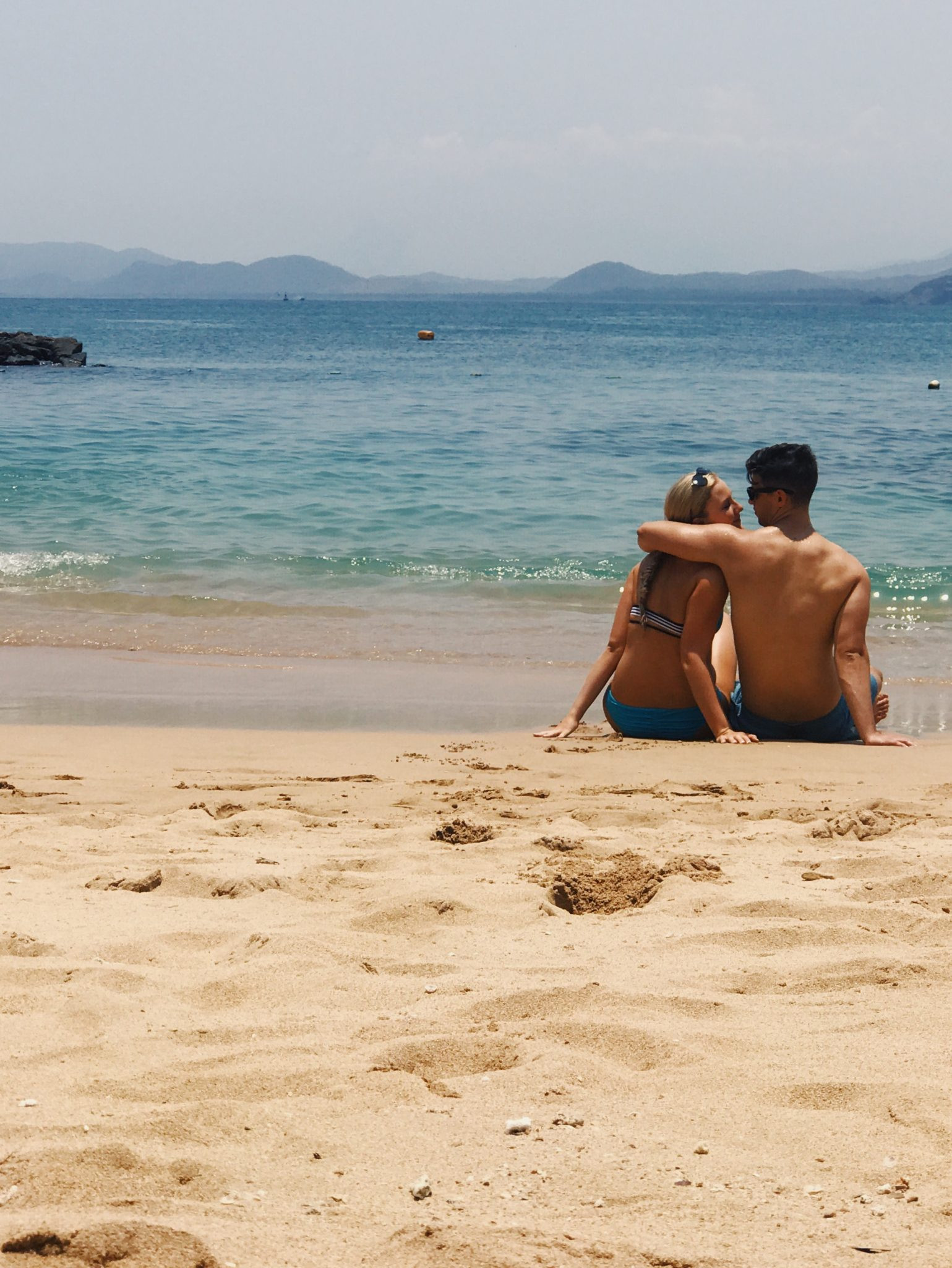 Couple walking on the beach in Zihuatanejo at dusk, Mexico