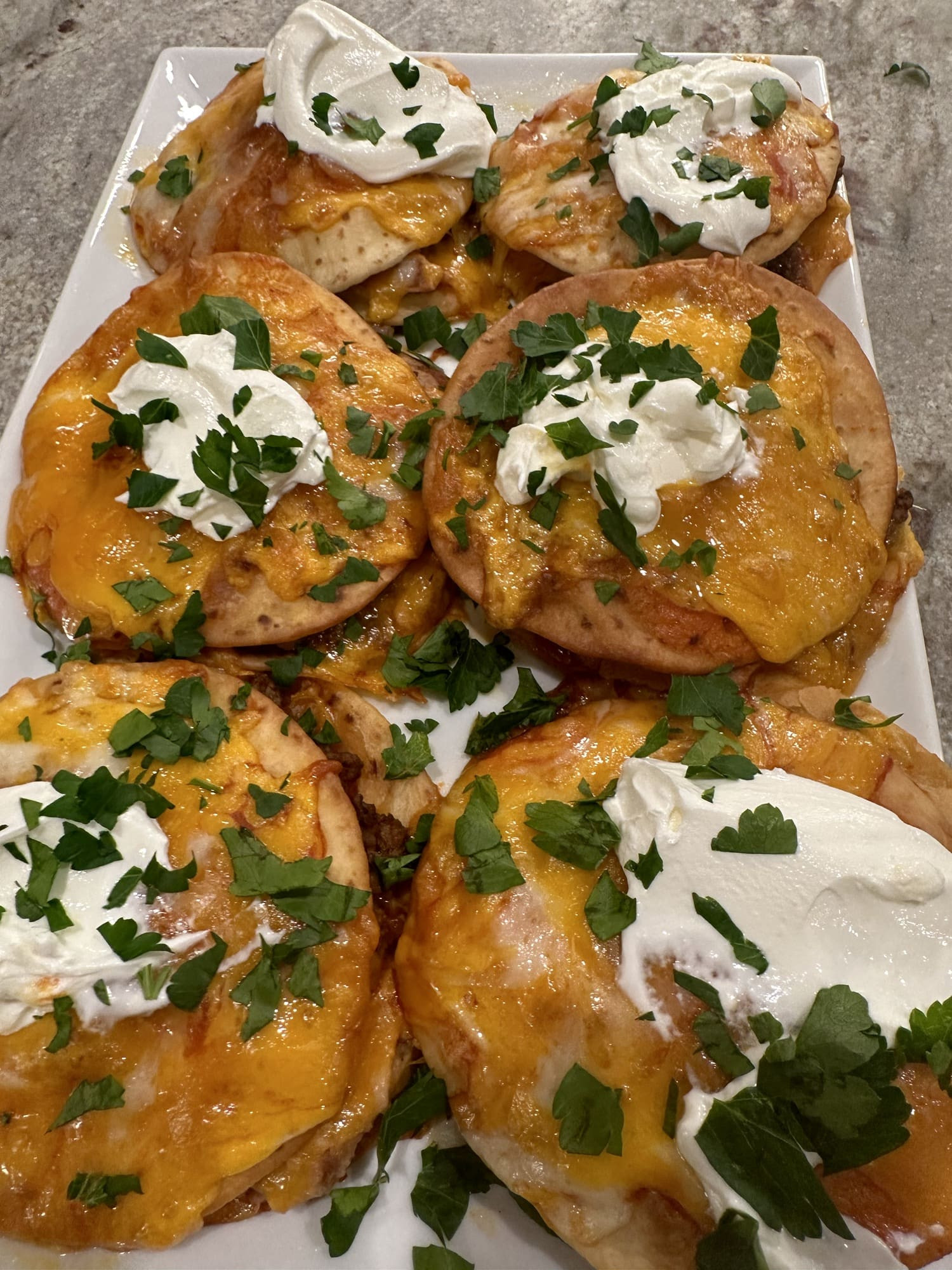 Two homemade Taco Bell Mexican Pizzas on plates, showcasing the golden-brown crispy tortillas and generous toppings.