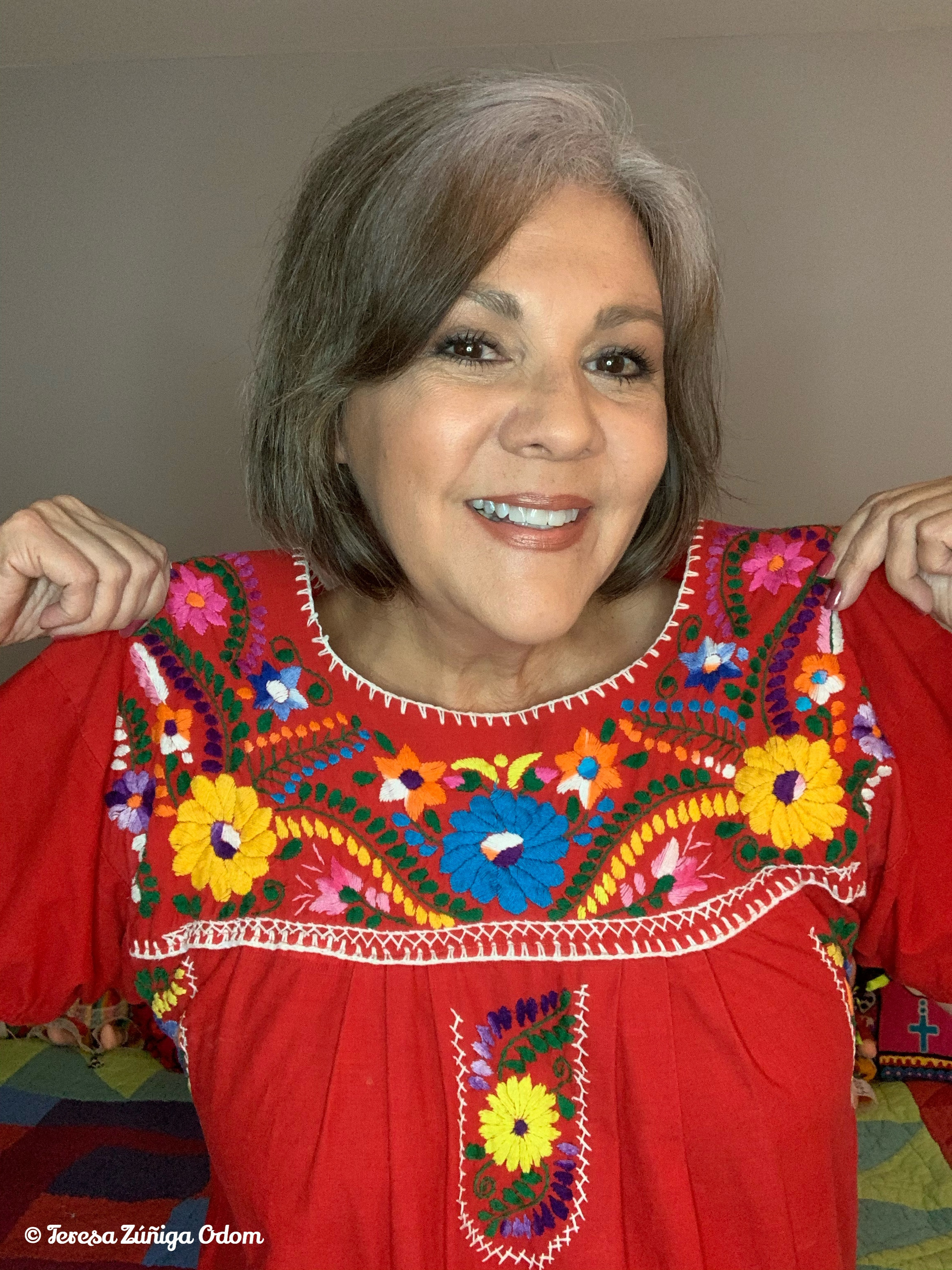 Model wearing a red Puebla dress, highlighting the dress's flowing silhouette