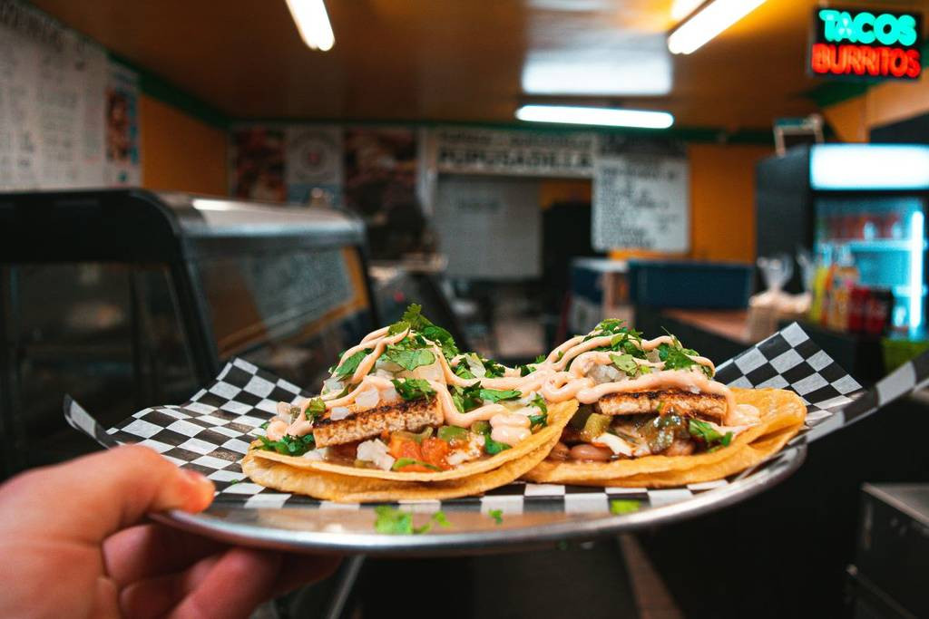 A plate of tacos inside a Mexican restaurant.