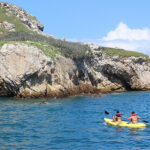 Kayaks explore the stunning coastline of Mexico's Marieta Islands, showcasing the natural beauty of this protected paradise.