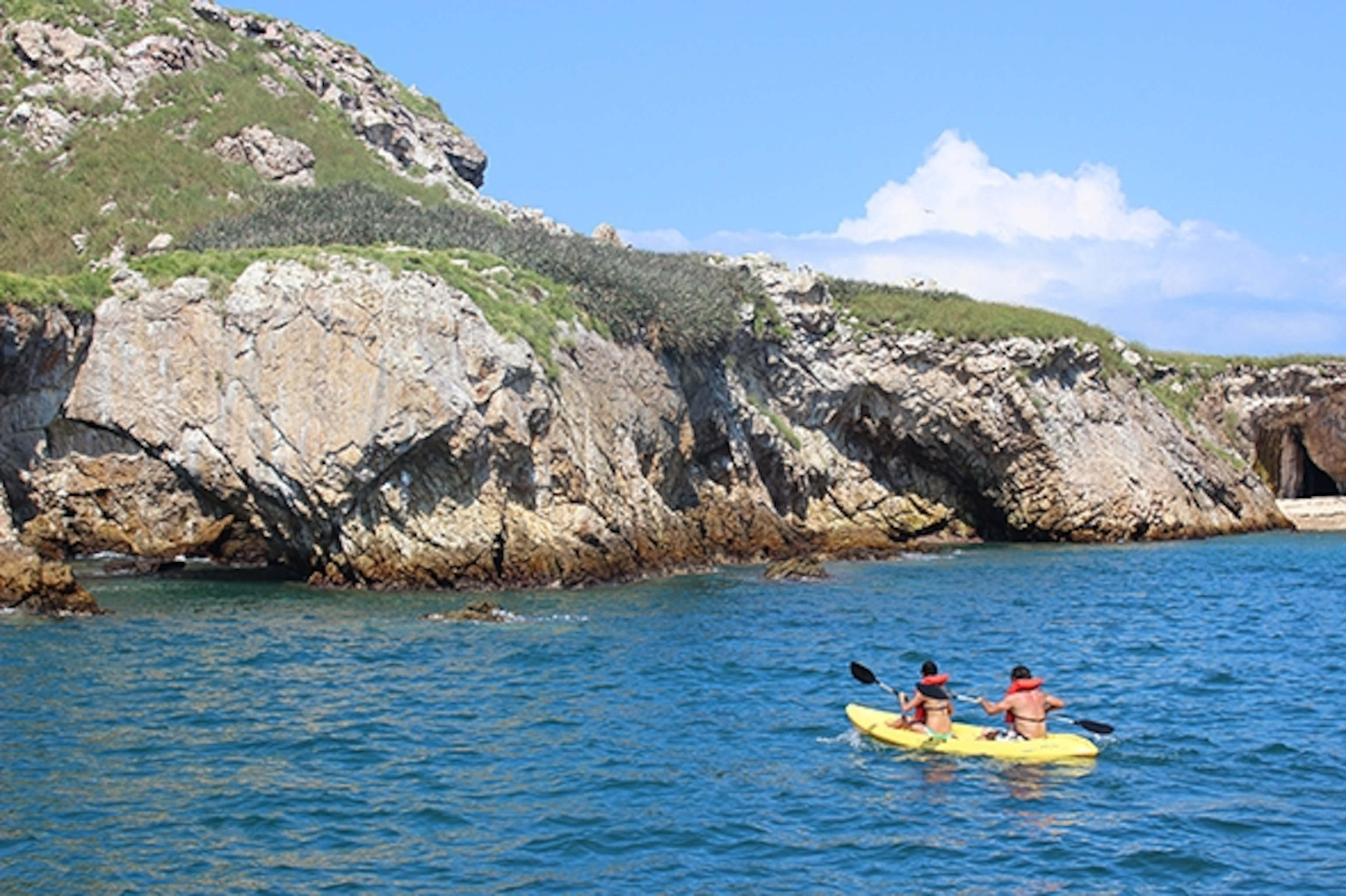 Kayaks explore the stunning coastline of Mexico's Marieta Islands, showcasing the natural beauty of this protected paradise.