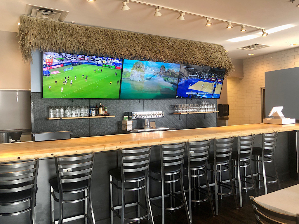 The bar area inside La Playita mexican seafood restaurant with beach themed decor