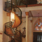 A wooden, circular staircase winds up from the back of the church to the choir loft.