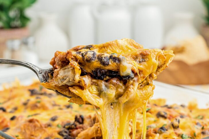 A slice of cheesy mexican chicken casserole on a plate, showcasing the layered ingredients