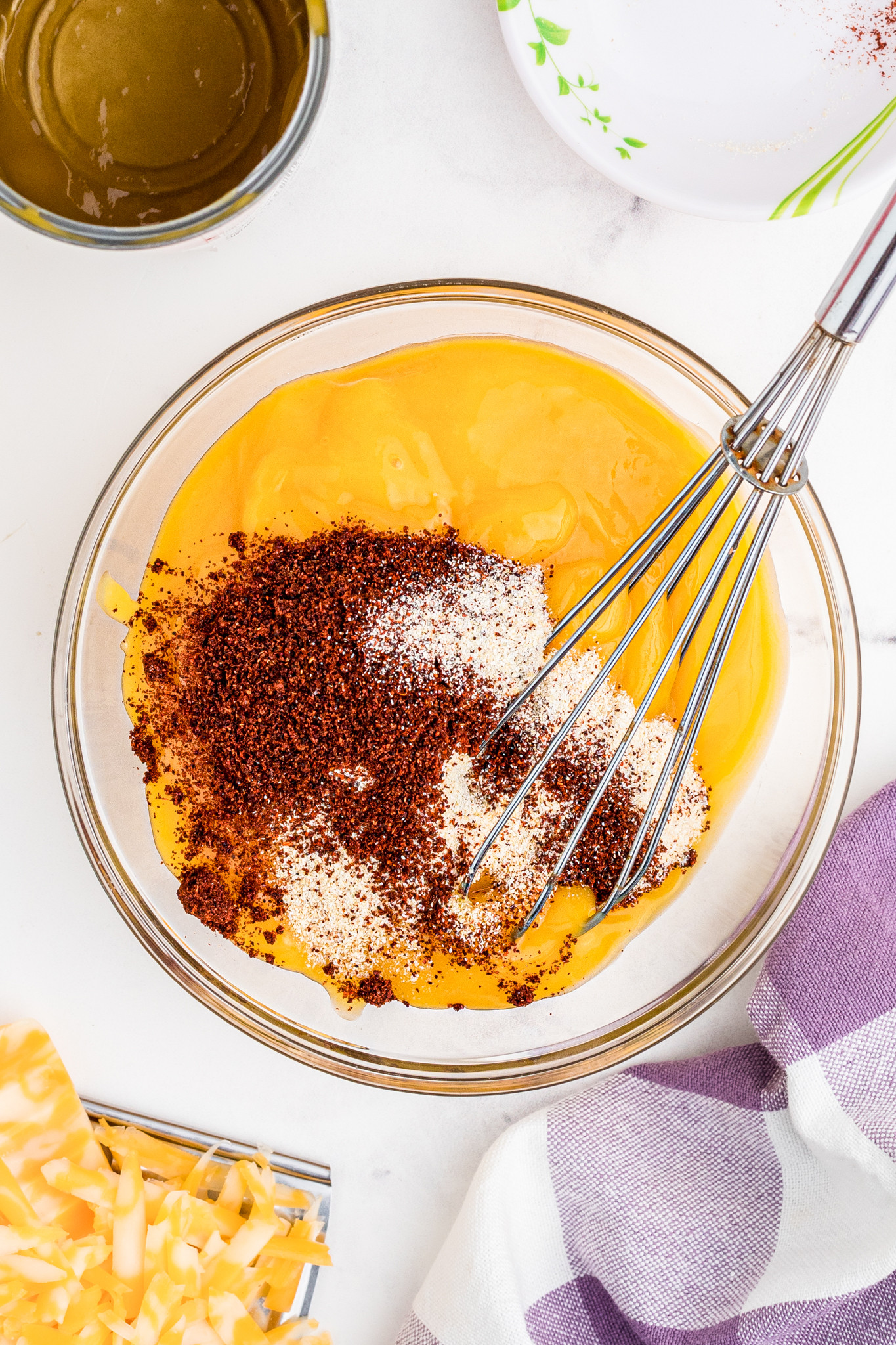 A bowl containing condensed cream of chicken soup mixed with taco seasoning, garlic powder, and onion powder, highlighting the simple sauce base