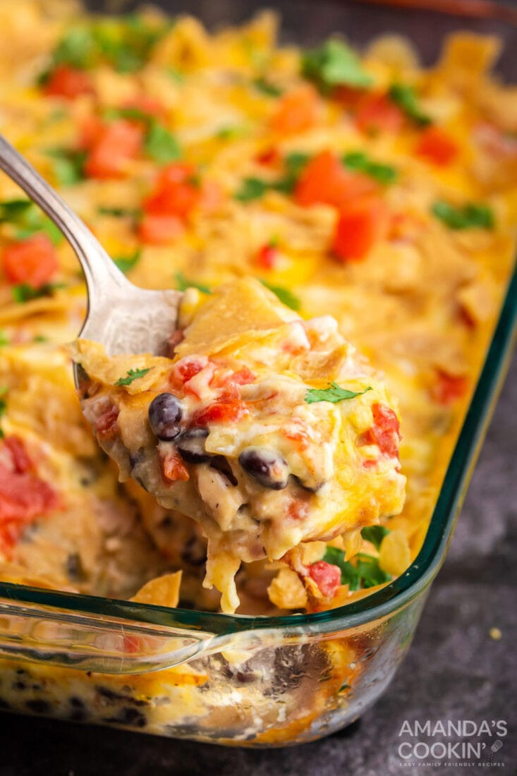 spoon lifting out a serving of mexican chicken casserole