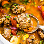 Mexican Meatball Soup (Albondigas Soup) in a white bowl with a spoon.