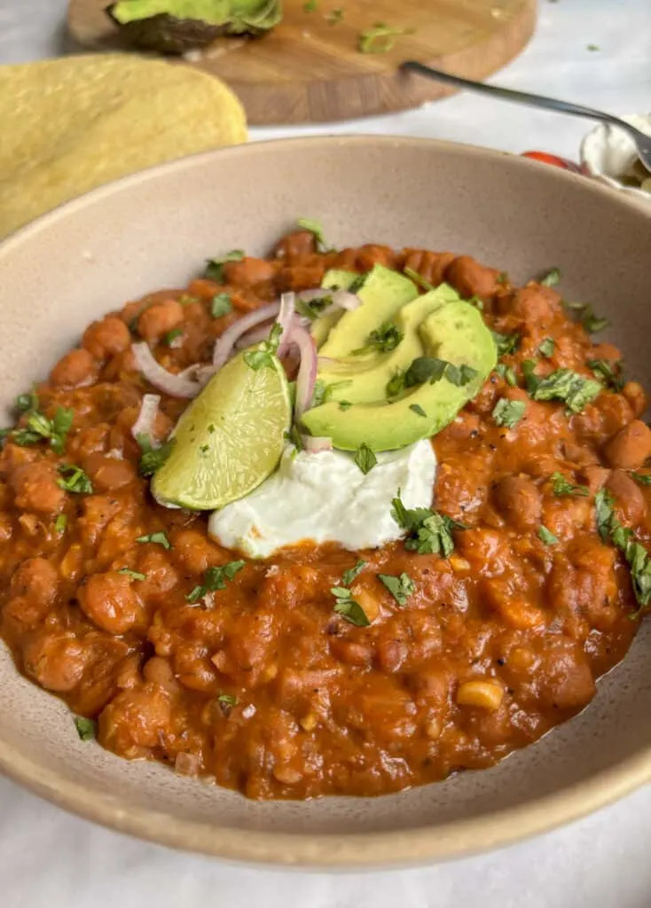 A close-up, mouthwatering shot of perfectly cooked Mexican pinto beans, showcasing their rich color and creamy texture.