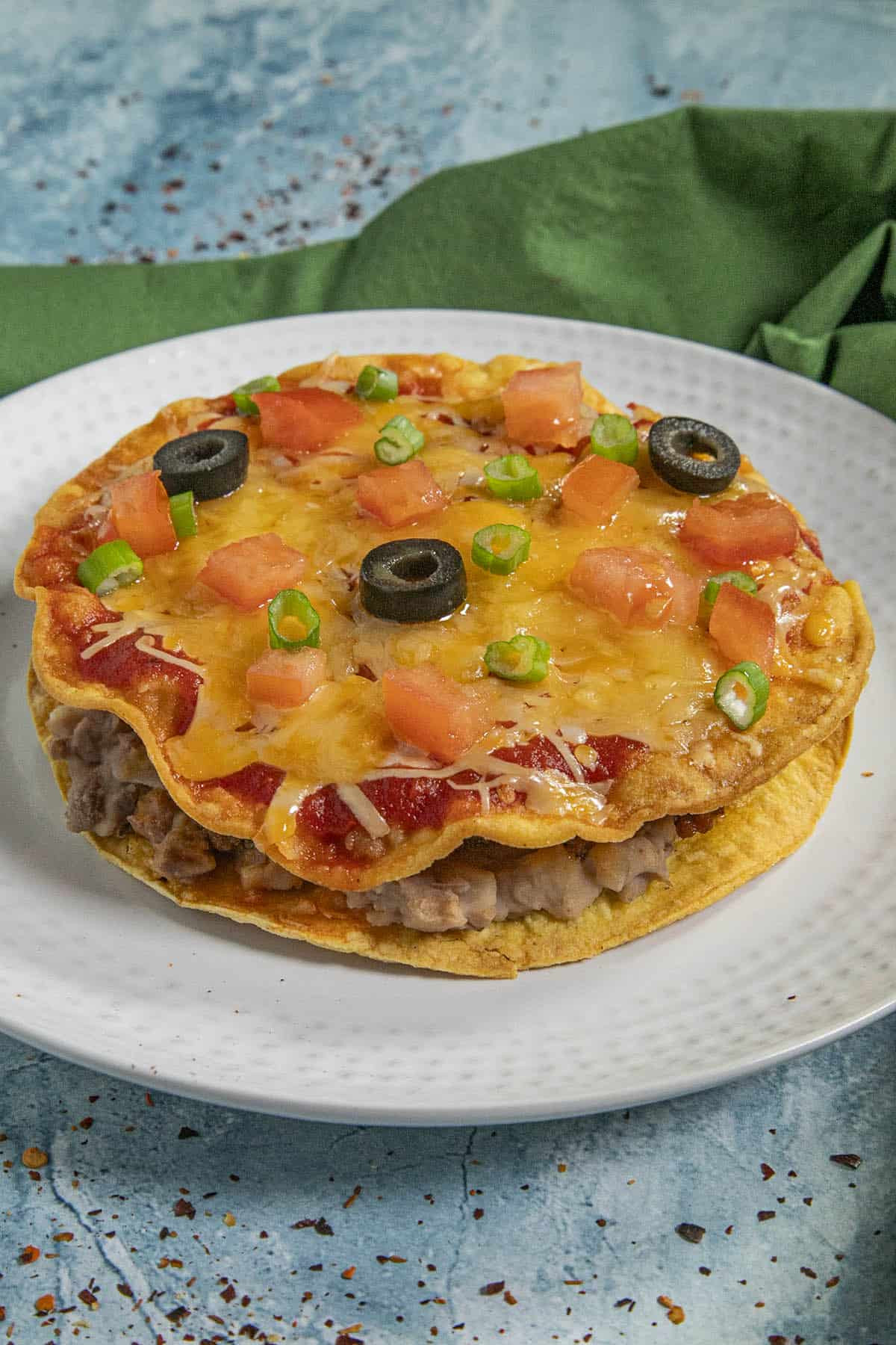 A single, perfectly plated Mexican pizza showcasing delicious layers and toppings