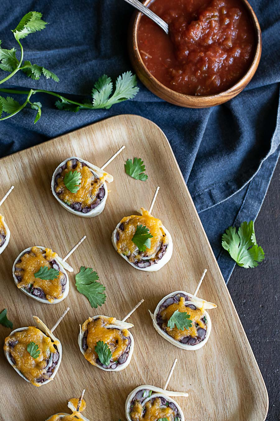 Detailed image of a single Mexican Pinwheel slice, showcasing the layers of tortilla, black bean filling, and melted cheese, emphasizing its appeal as a handheld Mexican food horderves.