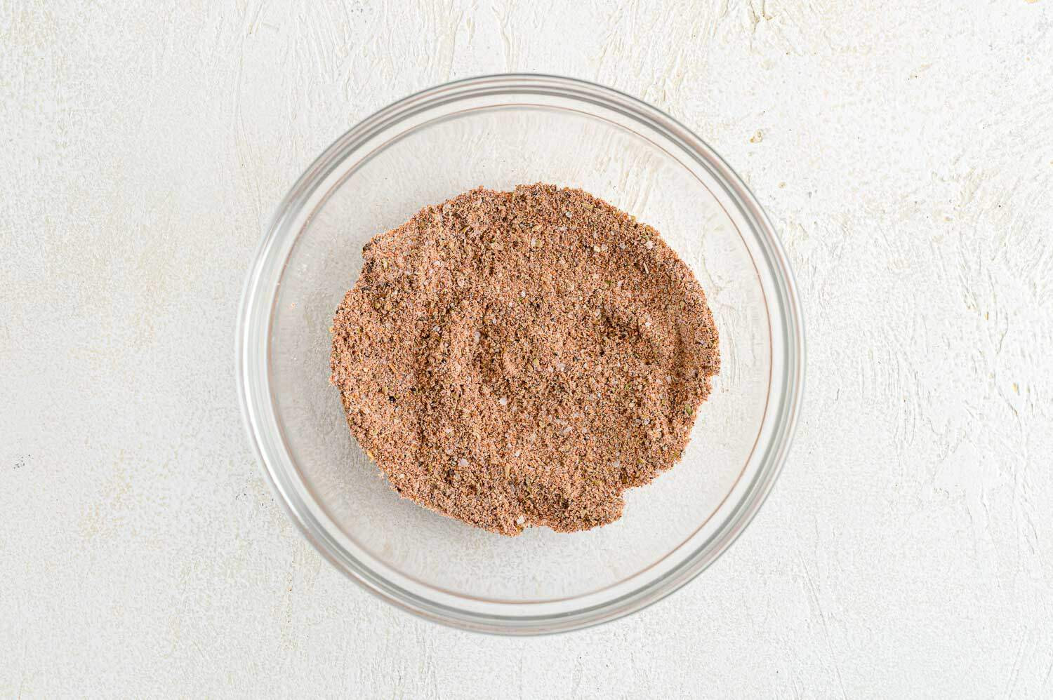 Image of a small bowl containing the spice mixture for Mexican Spaghetti, showcasing the combined flour and spices.