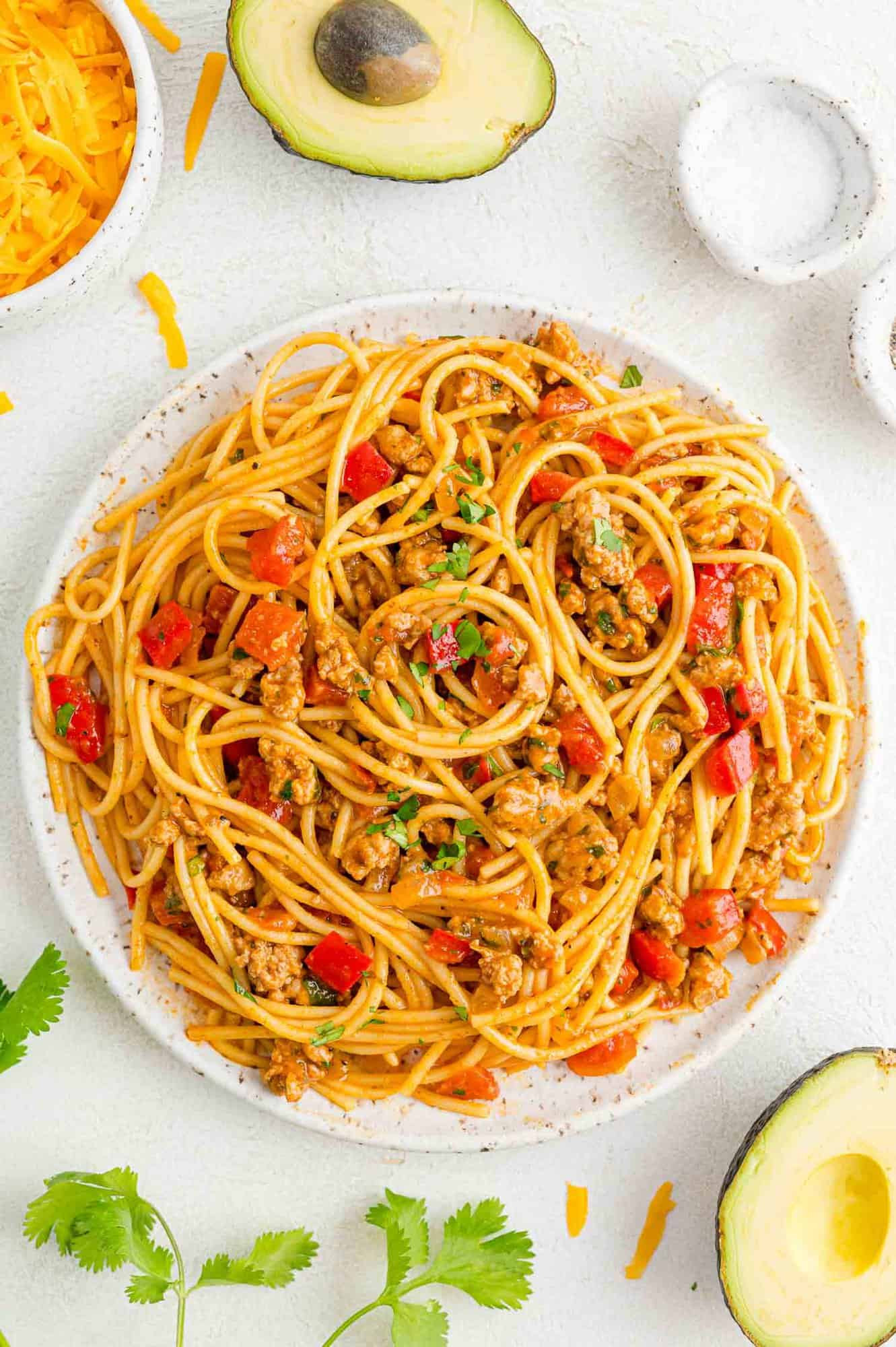 Image of a serving platter filled with Mexican Spaghetti, garnished with cilantro, showcasing the finished dish ready to be served.