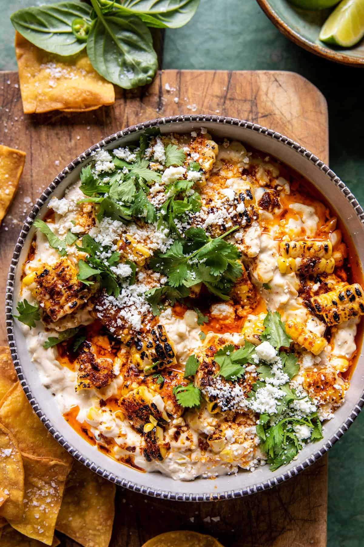 Overhead shot of Mexican Street Corn Dip in a serving dish with tortilla chips