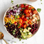 Mexican bean salad with vibrant tomatoes, beans, and a zesty dressing, showcasing its fresh and colorful ingredients