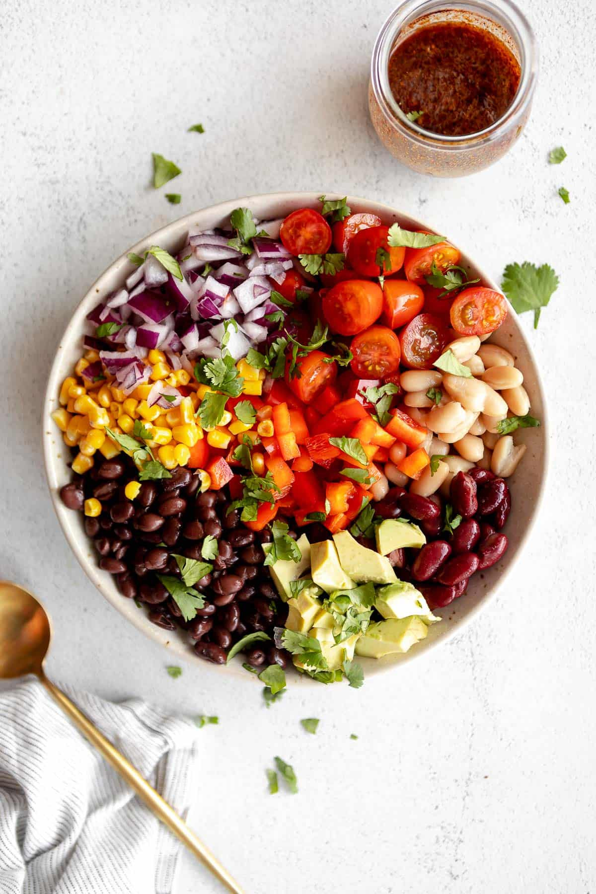 Mexican bean salad with vibrant tomatoes, beans, and a zesty dressing, showcasing its fresh and colorful ingredients