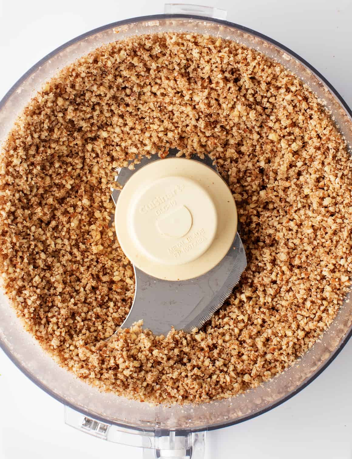 Finely chopped pecans in a food processor