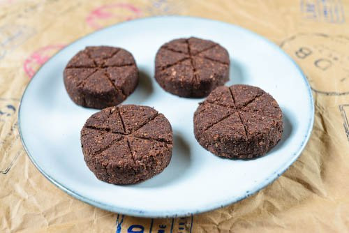 Close-up of shaping and scoring Mexican chocolate candy discs