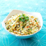 Mexican Coleslaw garnish with parsley in a Blue Pyrex bowl