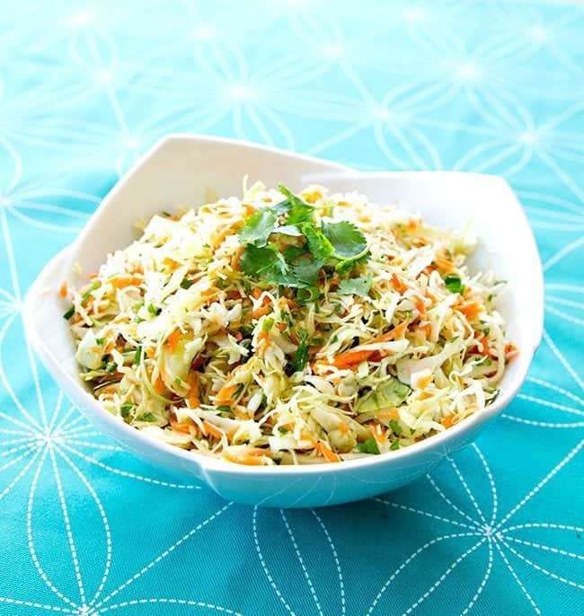 Mexican Coleslaw garnish with parsley in a Blue Pyrex bowl