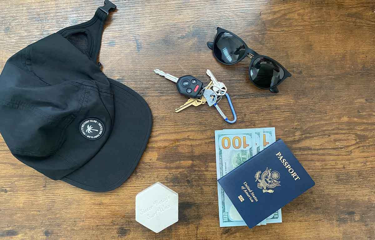 Essential items for a Mexico surf trip: HoStevie! Surf Cap, Cash, Wax, Passport, Keys, and Sunglasses, highlighting key travel necessities for surfers in Mexico.