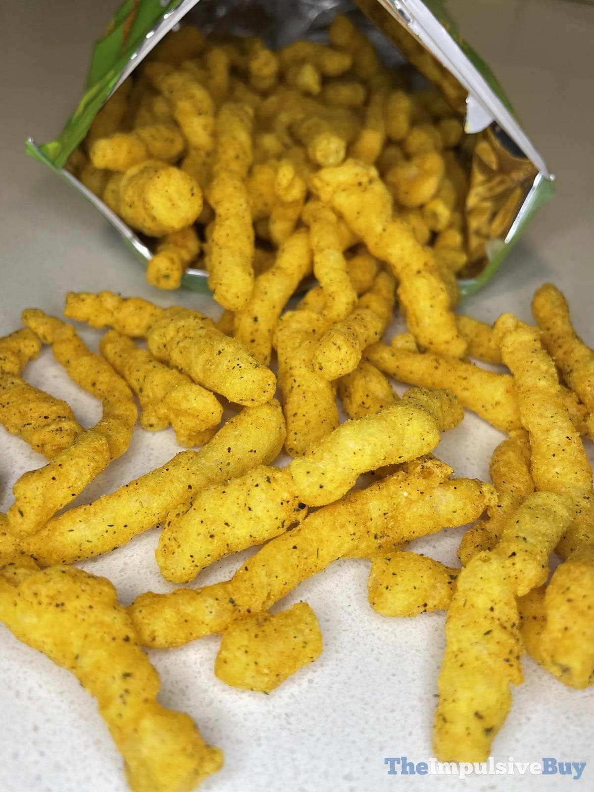 Close-up of Mexican Street Corn Cheetos being poured, highlighting chip texture and color