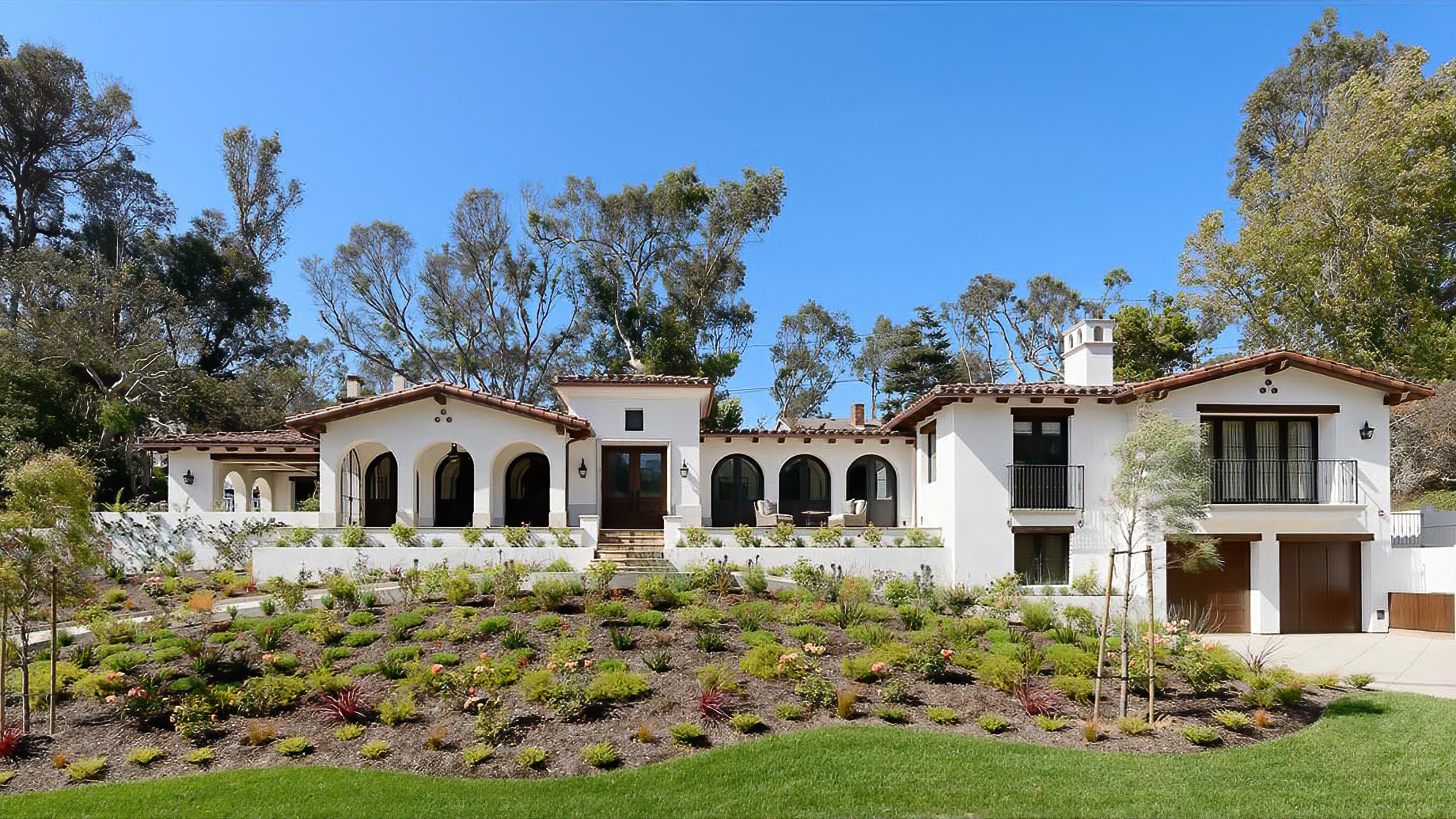 Mission Style Home with White Stucco and Stone Accents