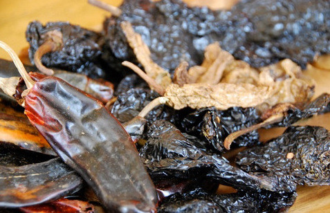 Sautéed dried chiles, a key step in preparing authentic Mexican Mole Poblano, showcasing their rich color and texture after frying.