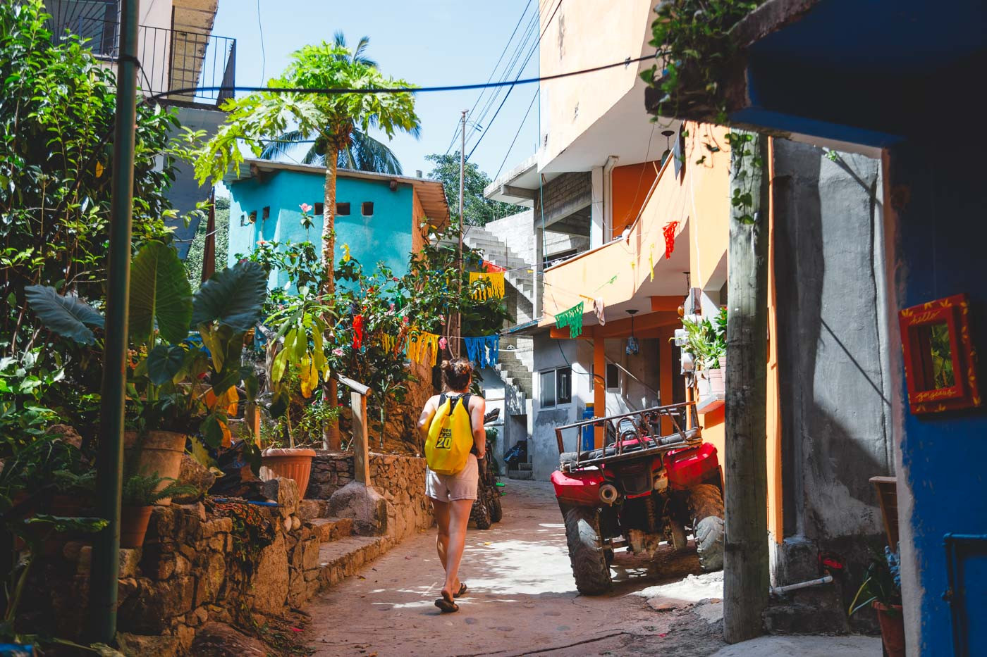 A woman with a waterproof bag exploring the bohemian-style side streets of Yelapa.