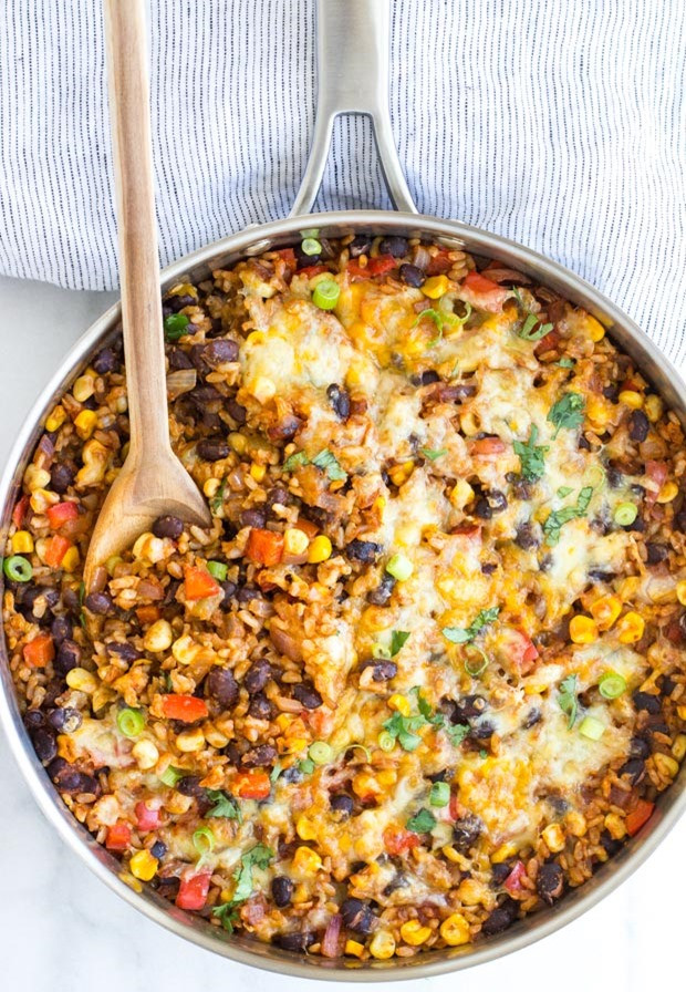 Overhead view of the skillet with sautéed onions and spices, the base for a flavorful Mexican Rice Casserole.