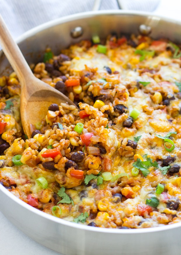 Close-up shot of One Skillet Mexican Rice Casserole, bubbling and golden brown, showcasing the melted cheese and colorful ingredients.