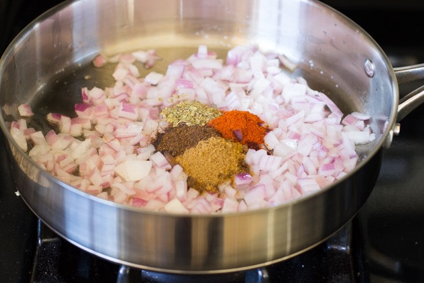 Sizzling onions and spices in a skillet, the first step to a flavorful Mexican casserole.