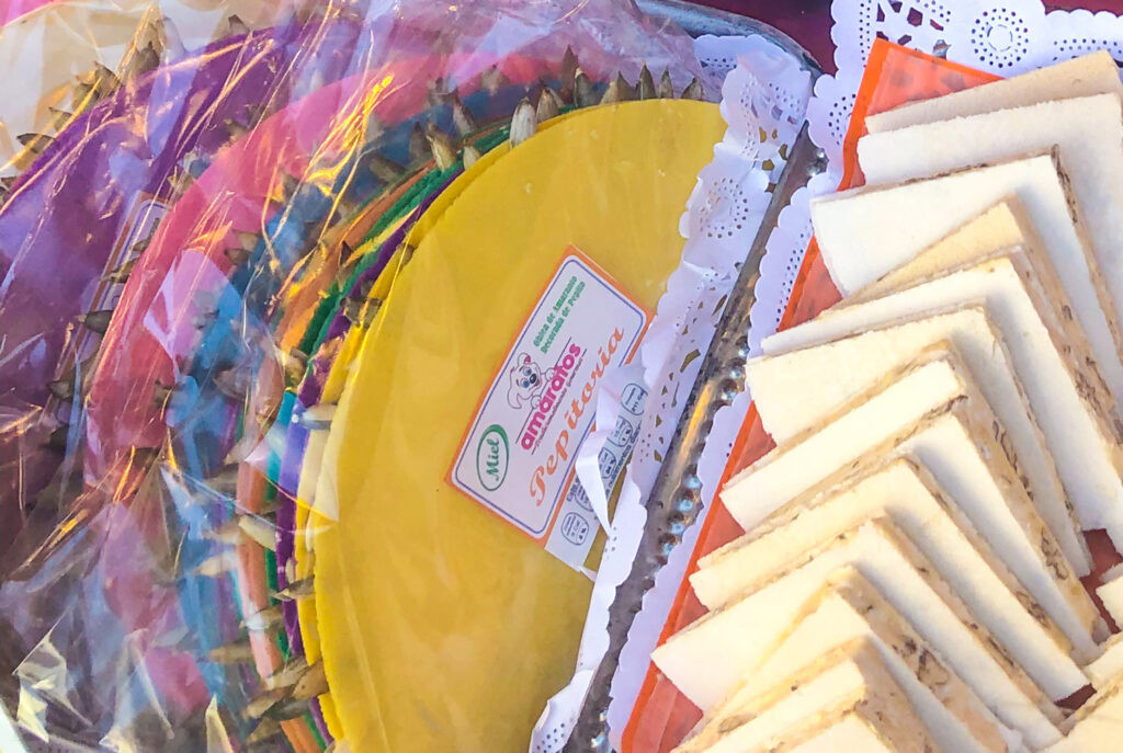 Colorful Pepitorias, a traditional Mexican street food candy made of wafers and honey, decorated with pumpkin seeds.