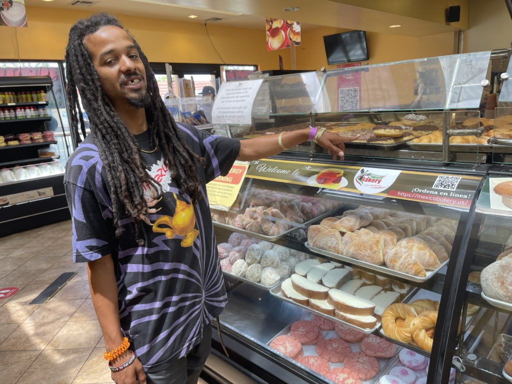 Customer Yan Jones pointing to his favorite doughnut at Mexico Bakery in San Jose.