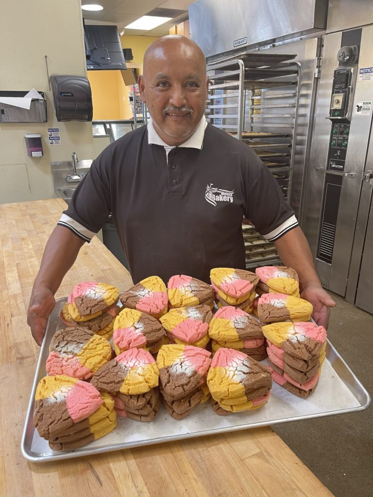 Melchor Landin showcasing Polvorónes cookies at his Mexico Bakery.