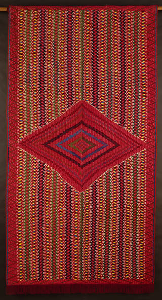 A red sarape from Mexico, showcasing tapestry weaving