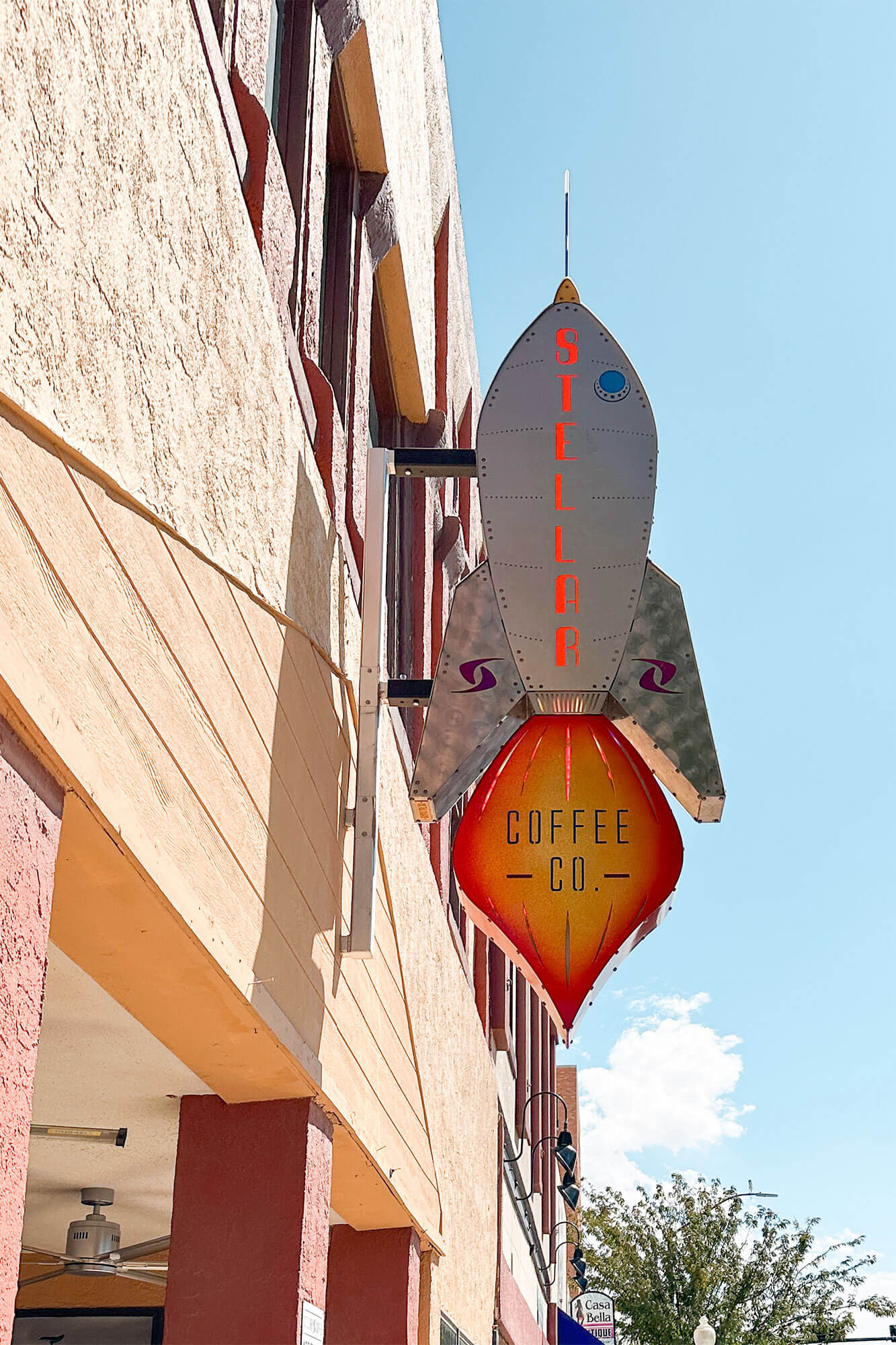 Stellar Coffee Co. shop sign in the shape of a space shuttle on a building in Roswell, New Mexico