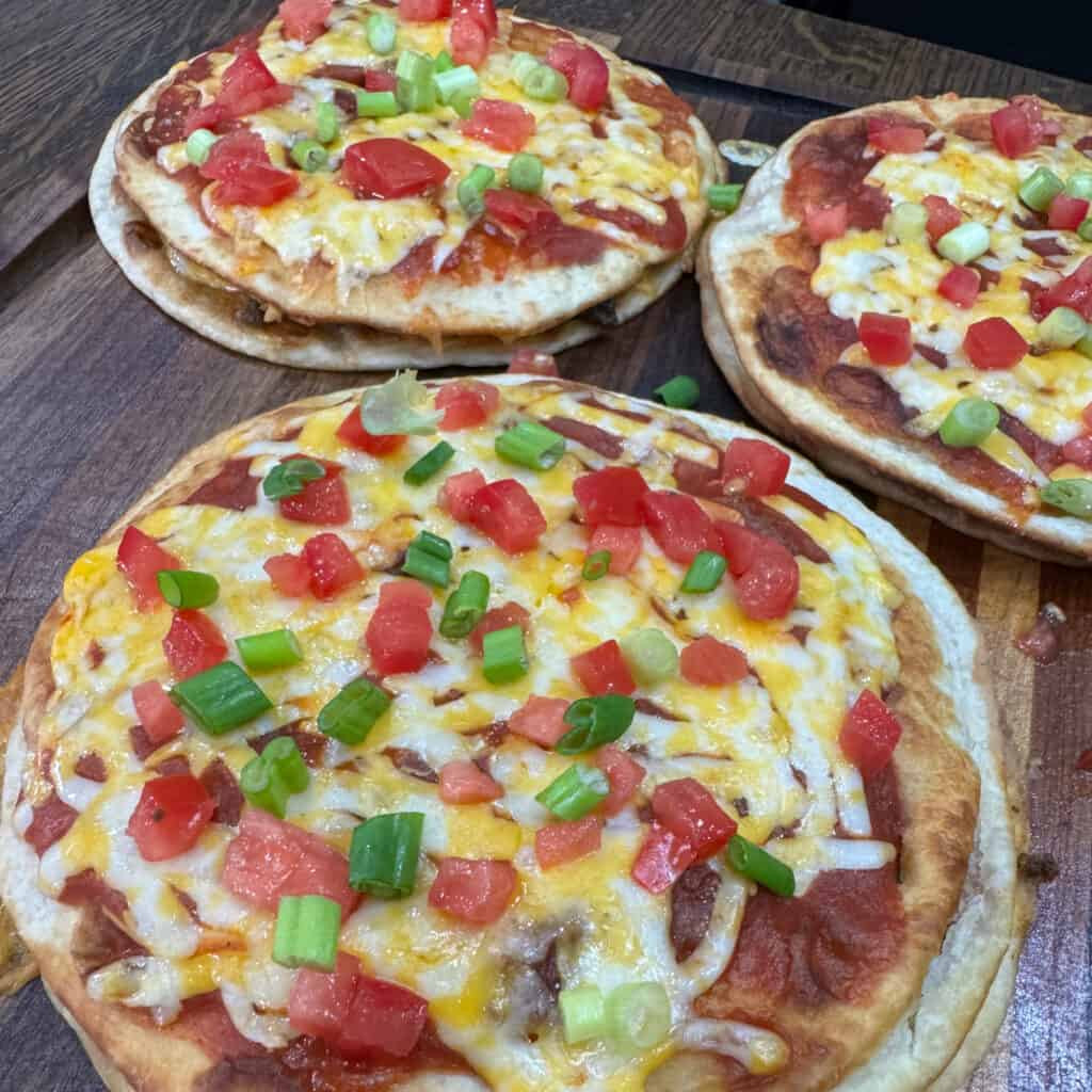 Delicious and easy homemade Mexican Pizzas topped with tomatoes and green onions