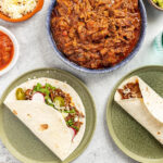 Shredded Beef Tacos perfect for a Mexican potluck, featuring tender beef and various toppings
