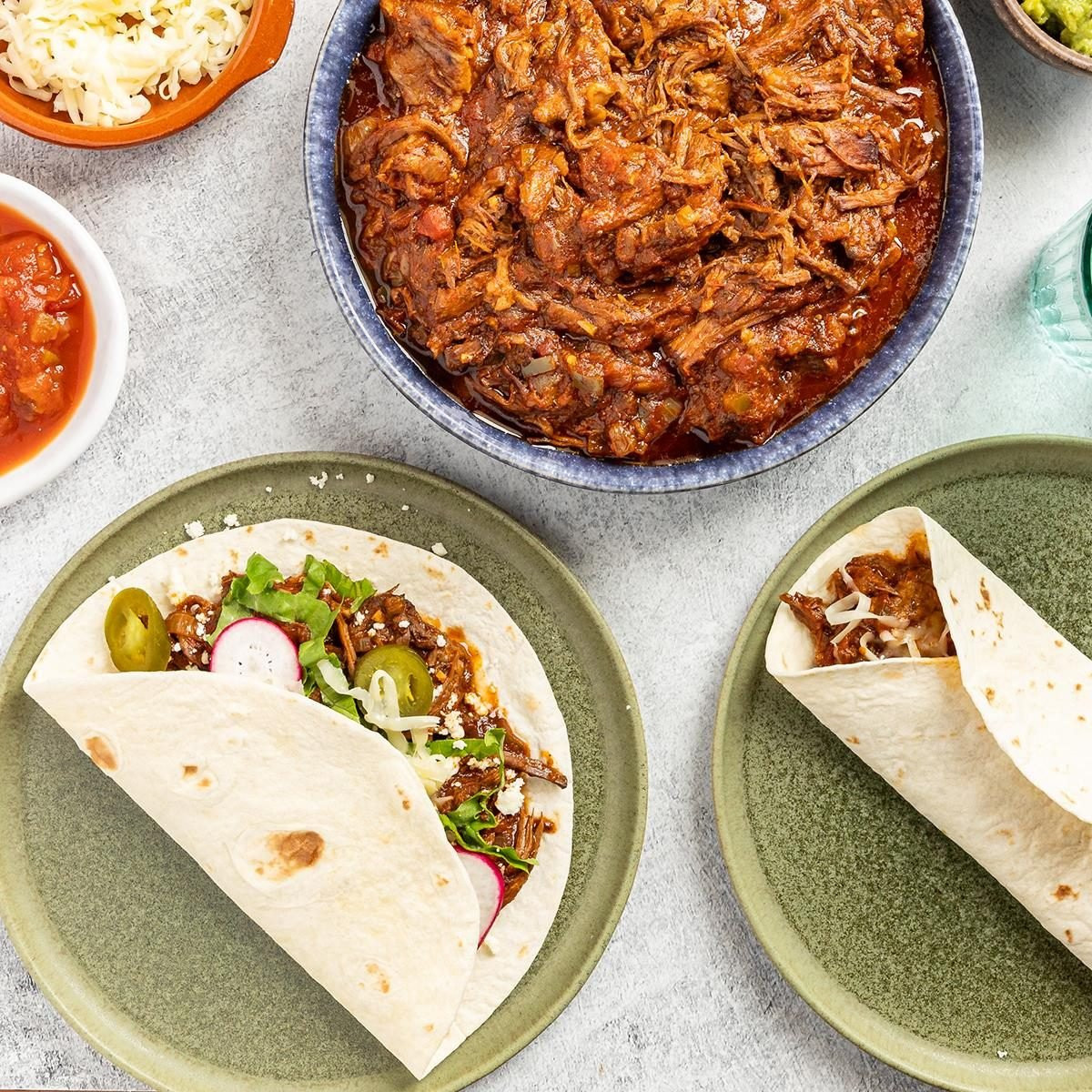 Shredded Beef Tacos perfect for a Mexican potluck, featuring tender beef and various toppings