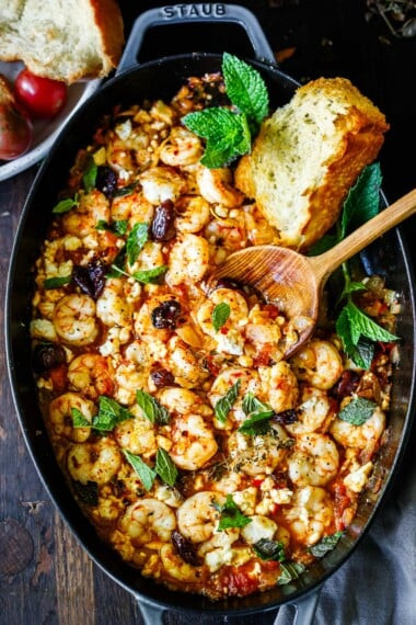 Image of Greek Shrimp Saganaki with feta and mint served in a two-handled skillet.