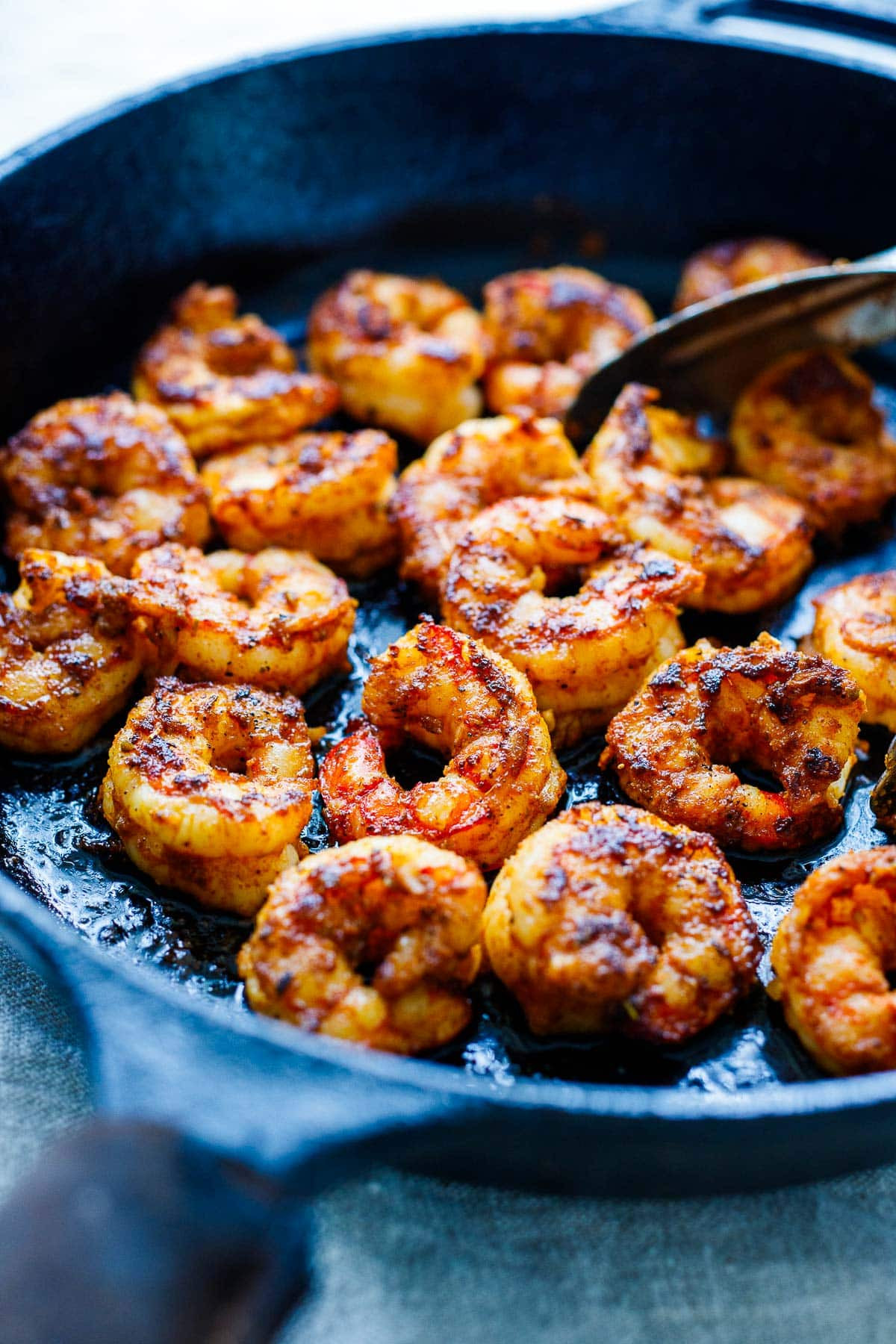 Mexican shrimp recipe cooking in a hot skillet, showing the searing process.