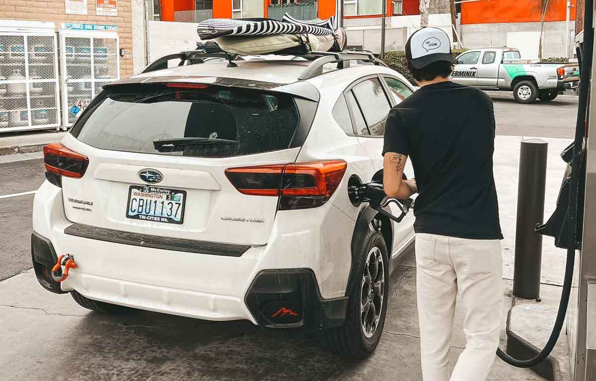 Refueling a car in San Ysidro, San Diego, before crossing the border, emphasizing the importance of starting with a full tank for surfers in Mexico.